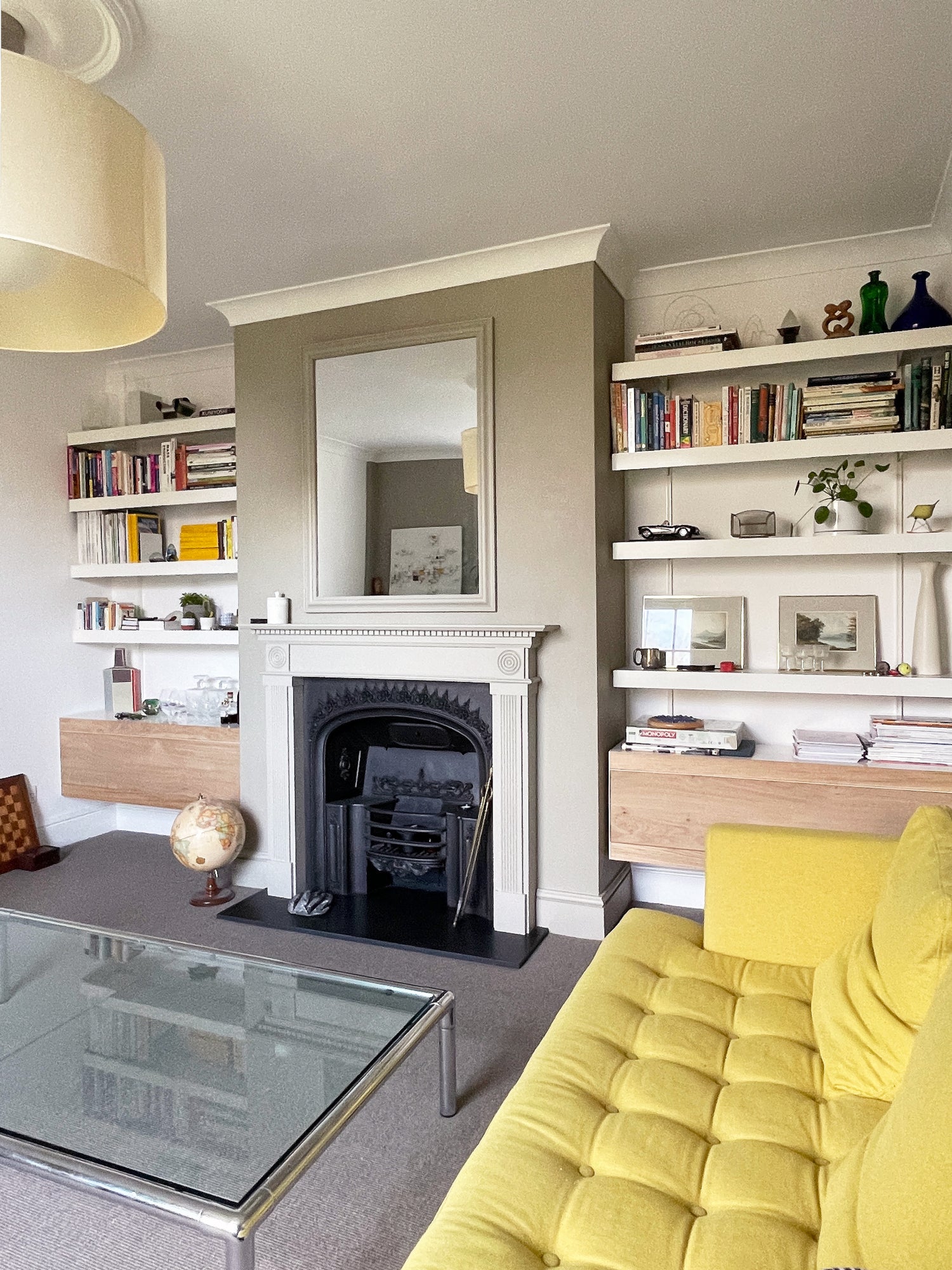 Living room with modern alcove shelving system in white and oak