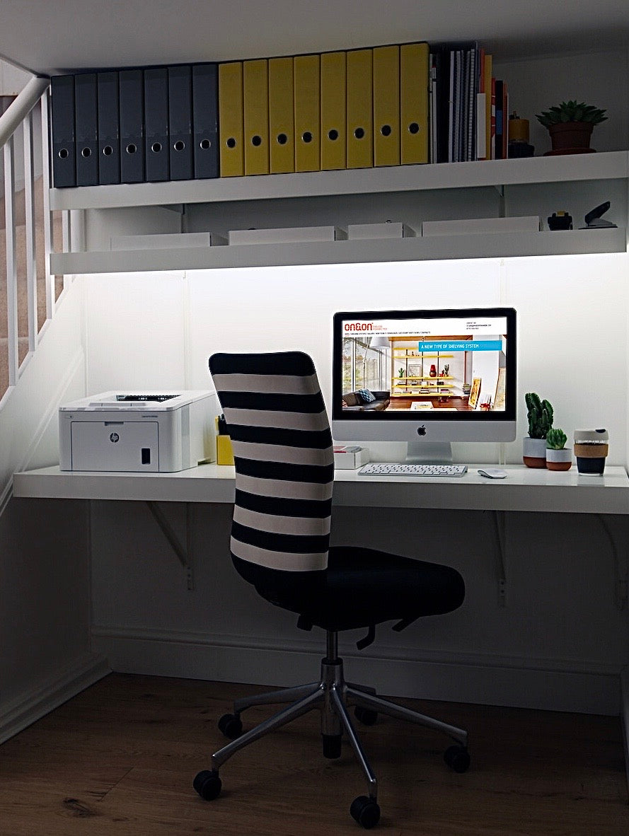 Small modern home office with wall mounted desk with lighting shelves
