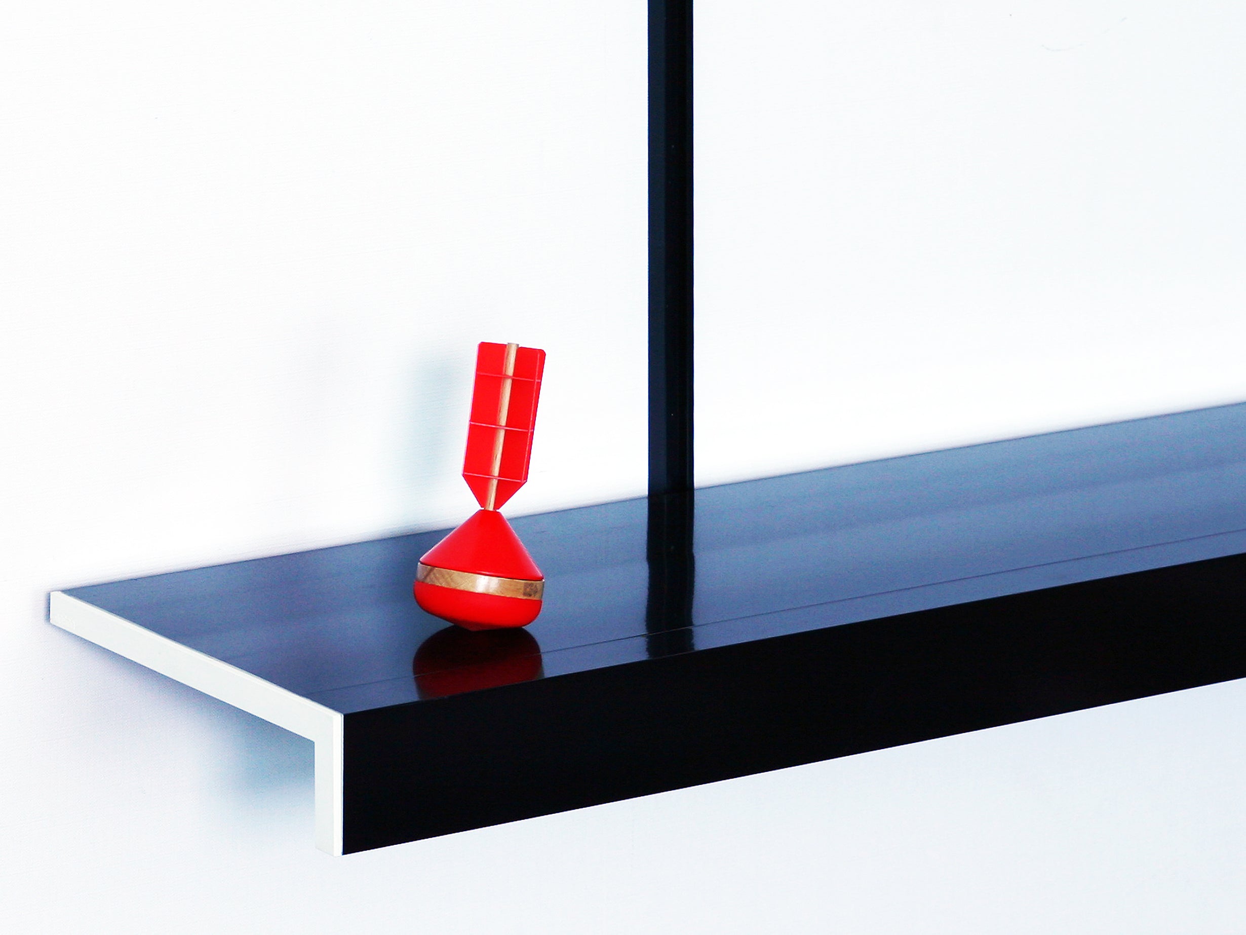 Black wall shelf by ON&ON with white ABS endcap