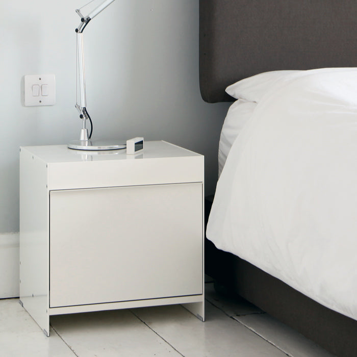 modern bedside table in white next to bed