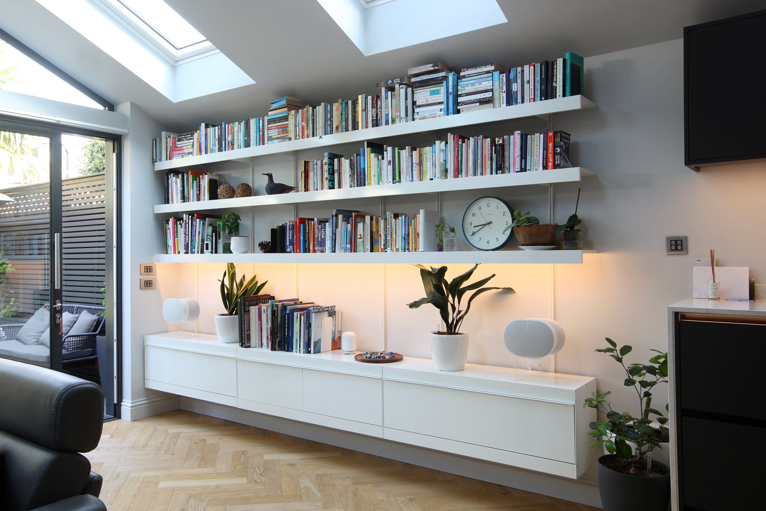 large wall mounted modular shelving system in new extension