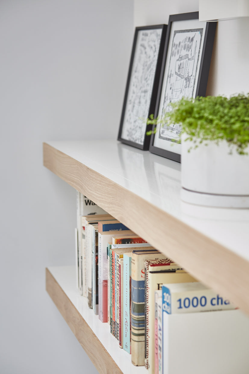 long white wall shelving with oak fronts