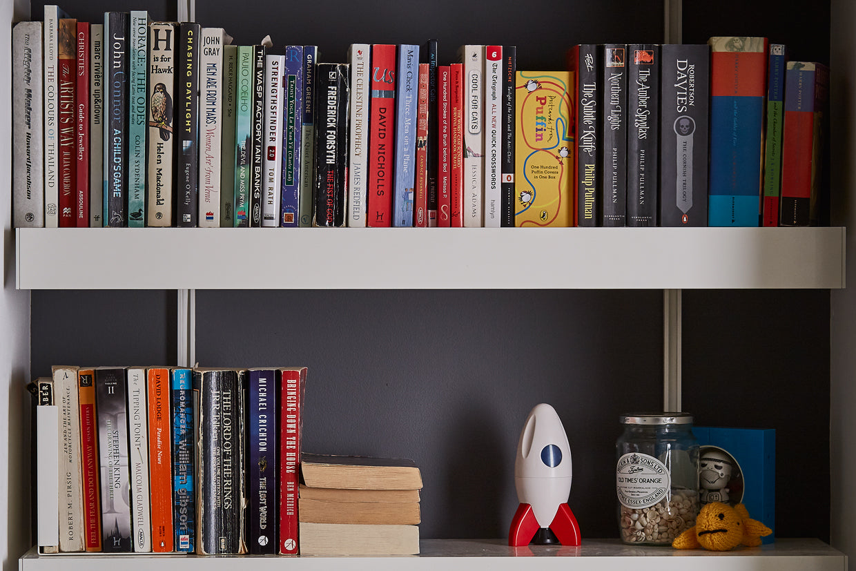 White book shelves with books in alcove