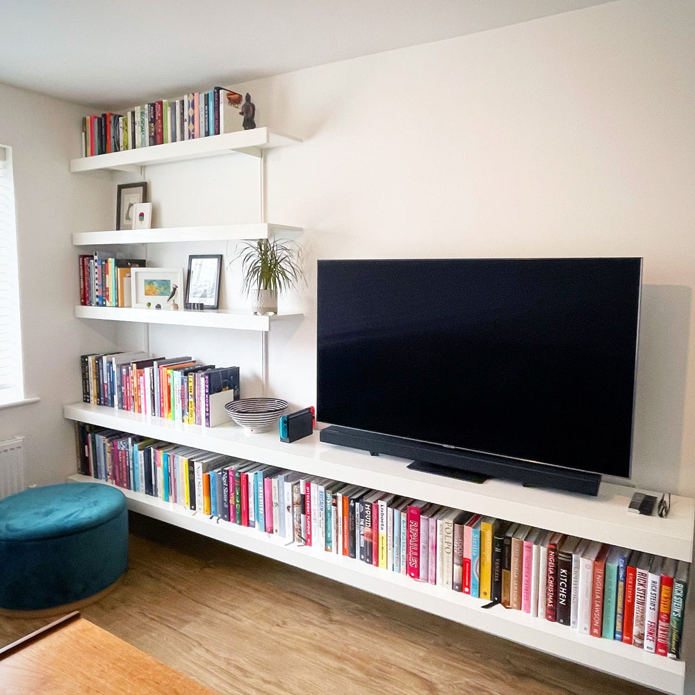 Shelving system with large TV and book collection in living room