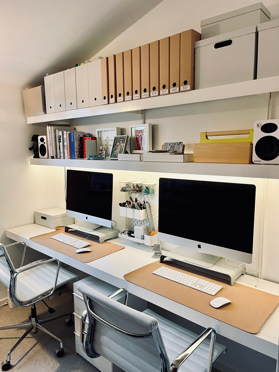 Home office shelving system with two computers and shelves above with files