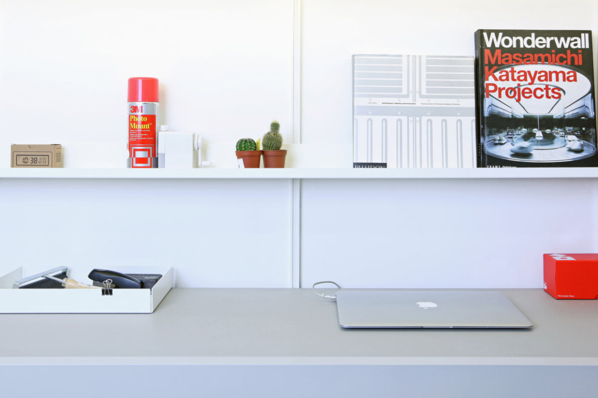 Mini shelf above wall mounted desk