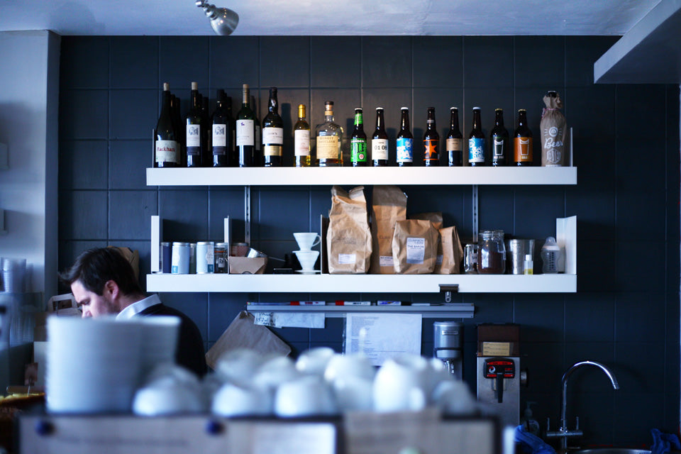 Retail shelving system wall mounted with bottles display in shop