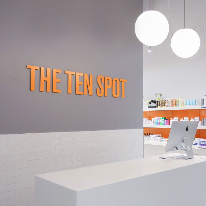 The Ten Spot beauty bar reception desk and wall shelving 