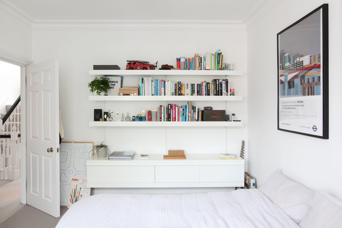 Bedroom shelving system in white, wall mounted cabinet and shelves above