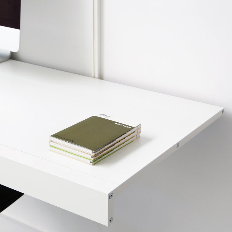 white wall desk with endcap details and small books
