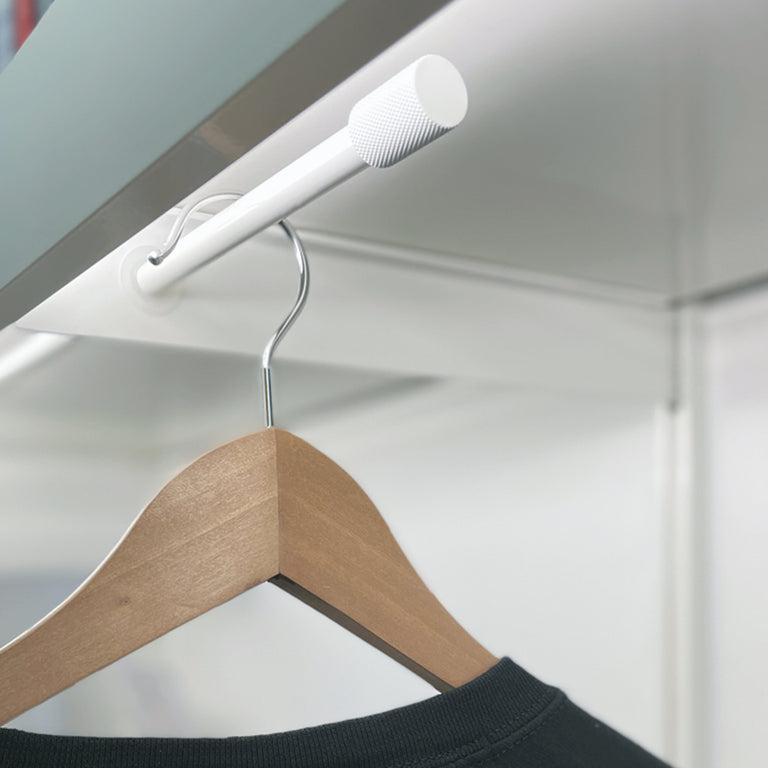 Hidden clothes hanger with white finish
