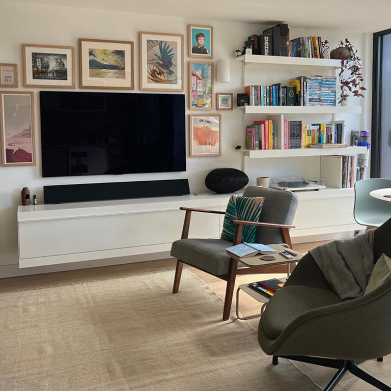 TV wall shelving system in white with wall mounted book shelves