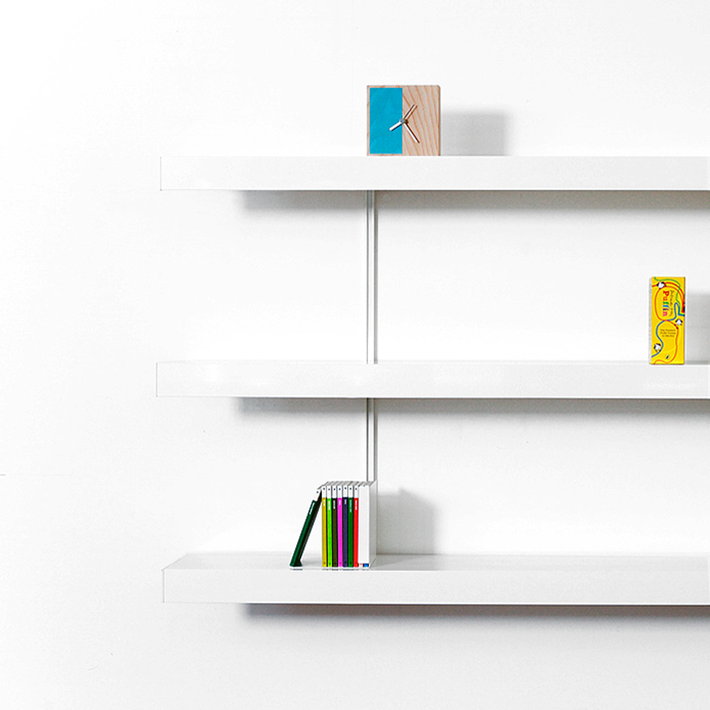 White shelving system with 3 x white aluminium shelves on  a white background