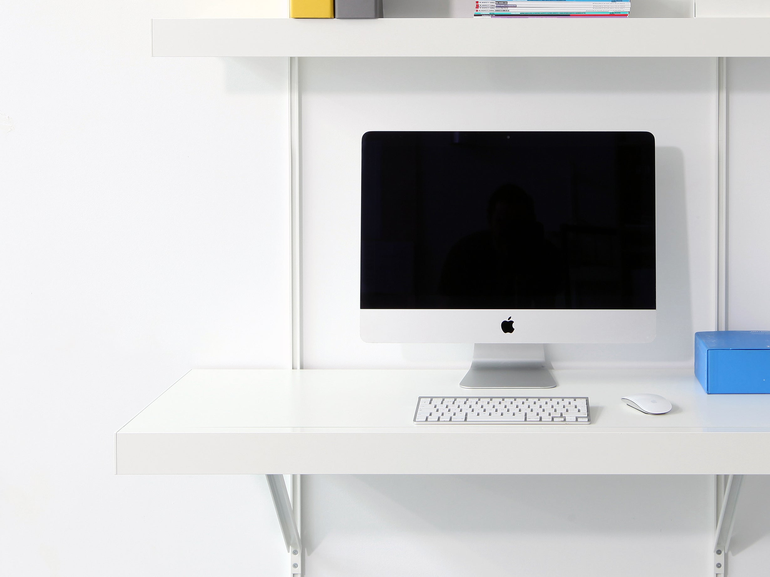 large wall mounted floating desk with shelves in white