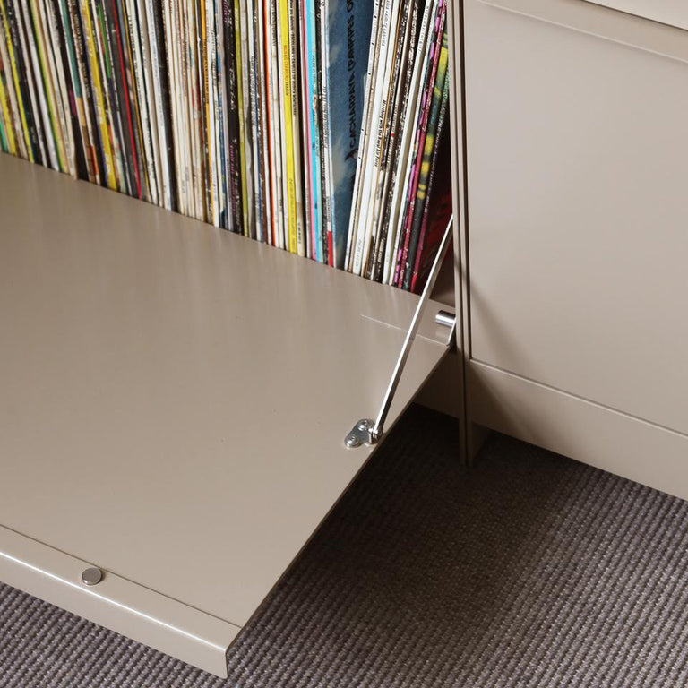Beige storage cabinet with open door revealing a collection of vinyl records.