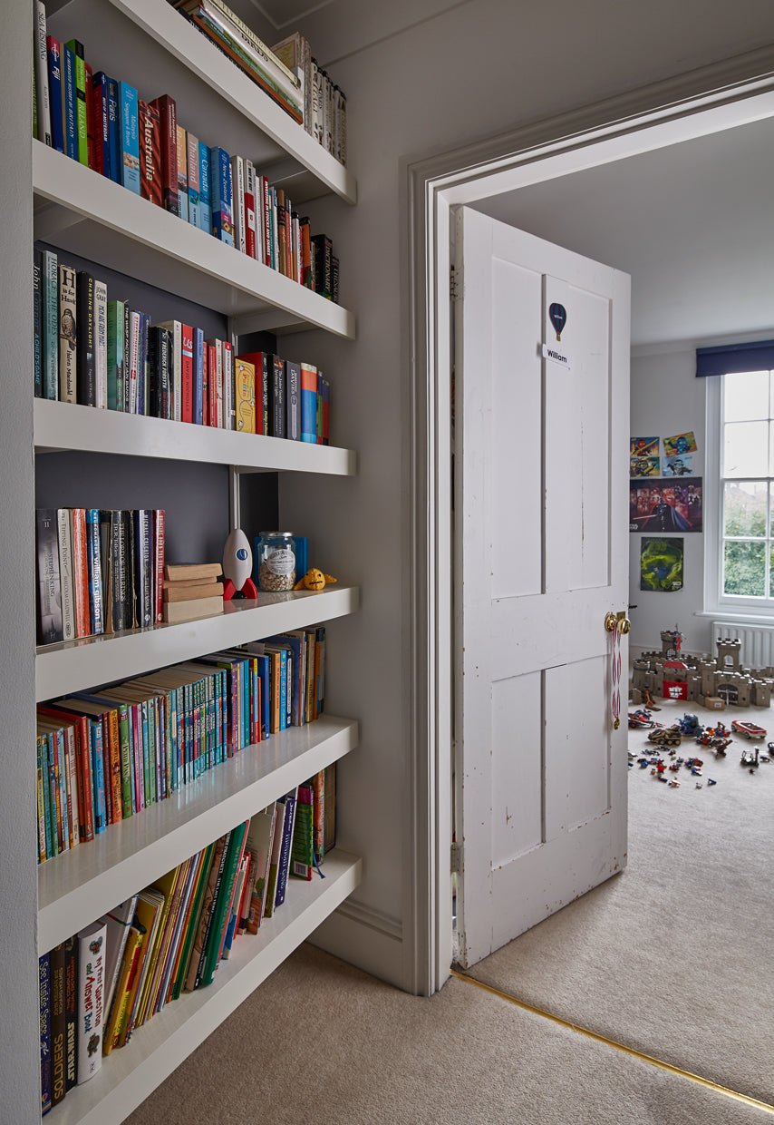 White book shelves mounted into small alcove