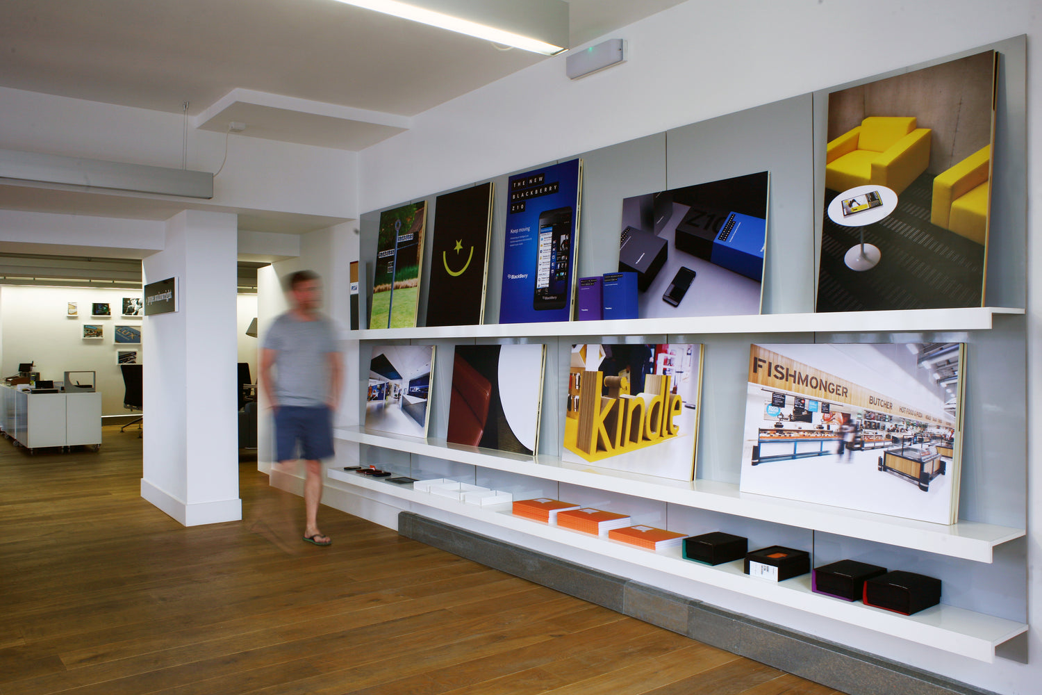 Long white office display shelving in design office