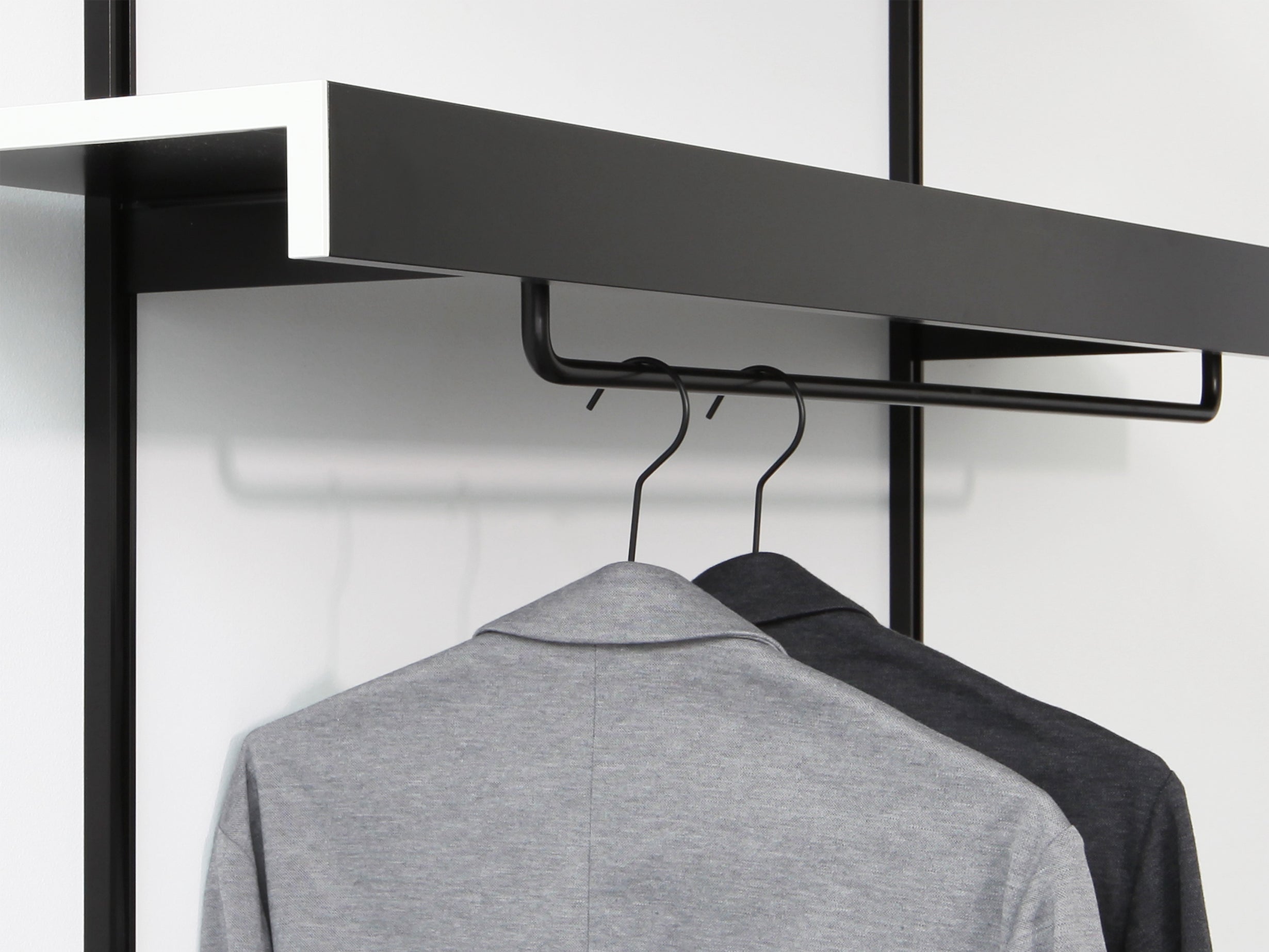 black modular shelves with black clothes rails