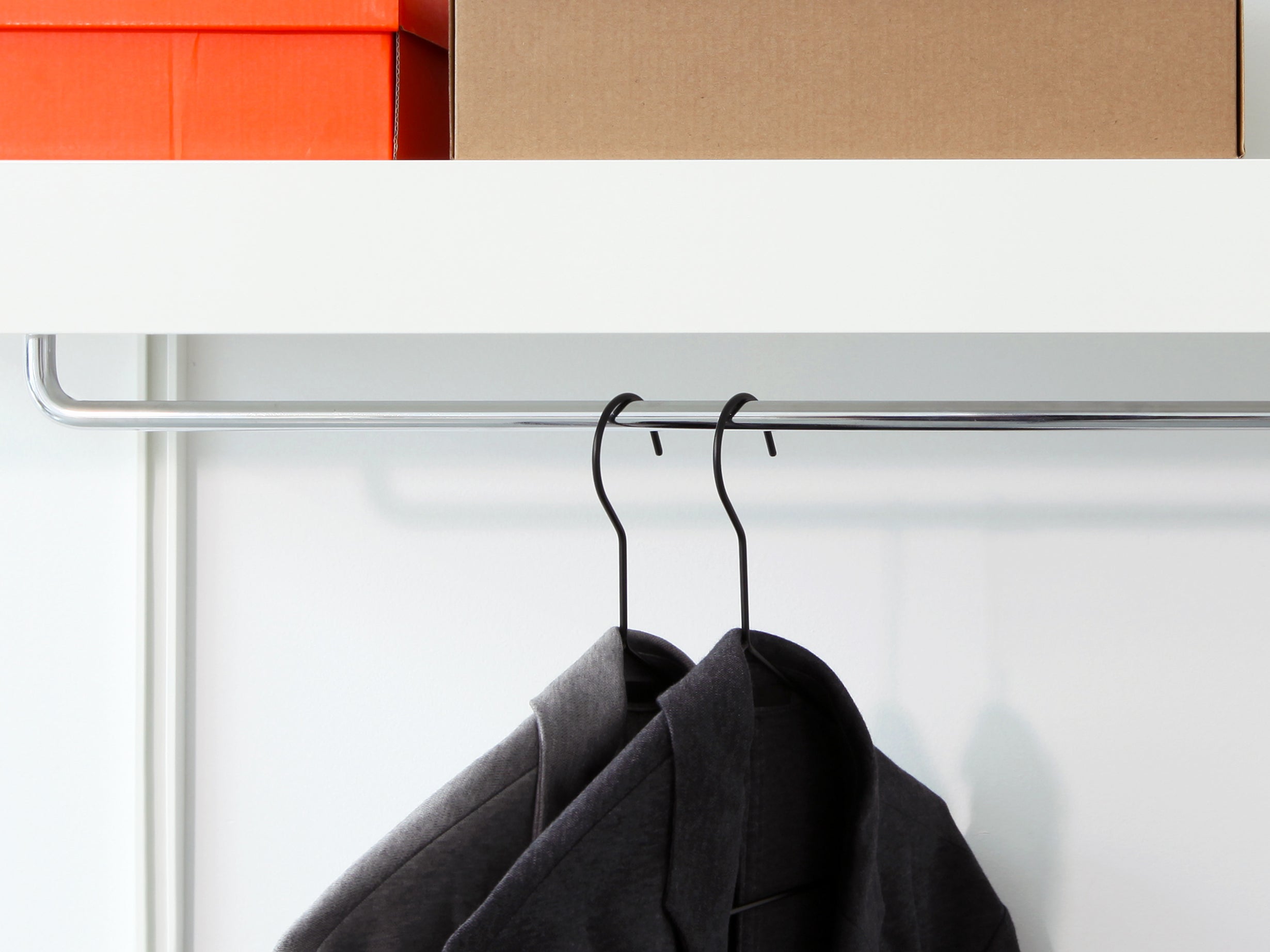 white modular shelves with chrome clothes rail