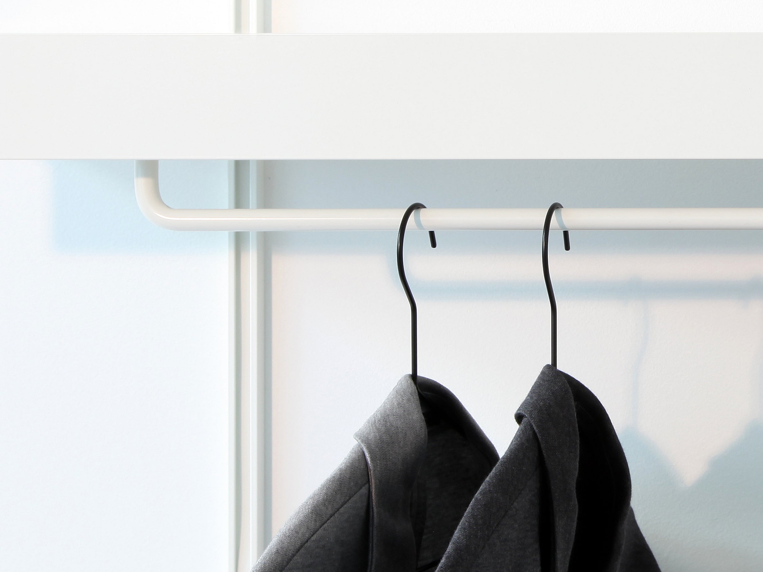 white clothes rail with wall shelves