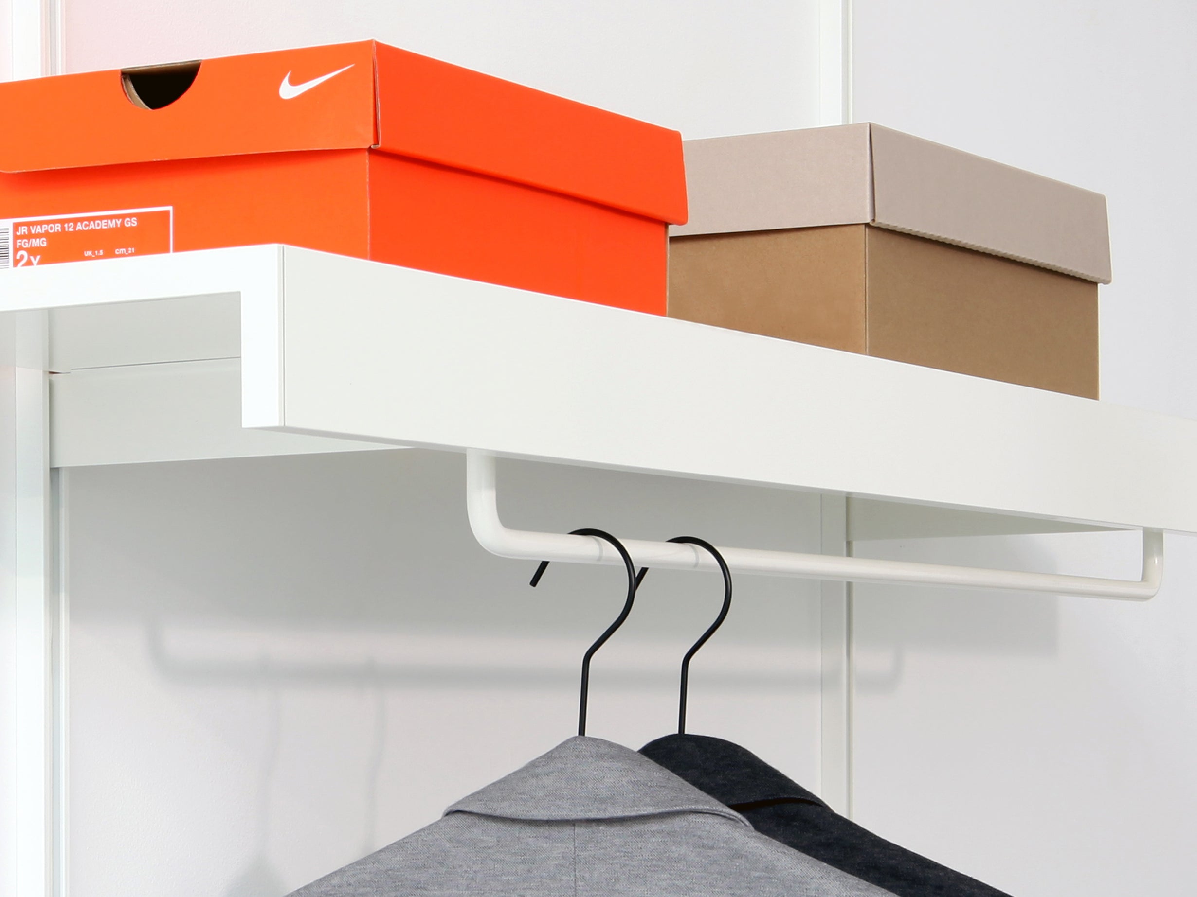 white wall shelves with white clothes rail
